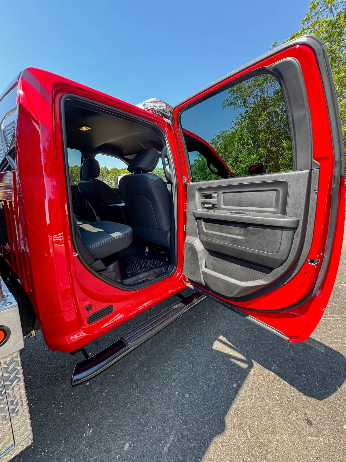 Rear cabin view with bench seat and open rear door.